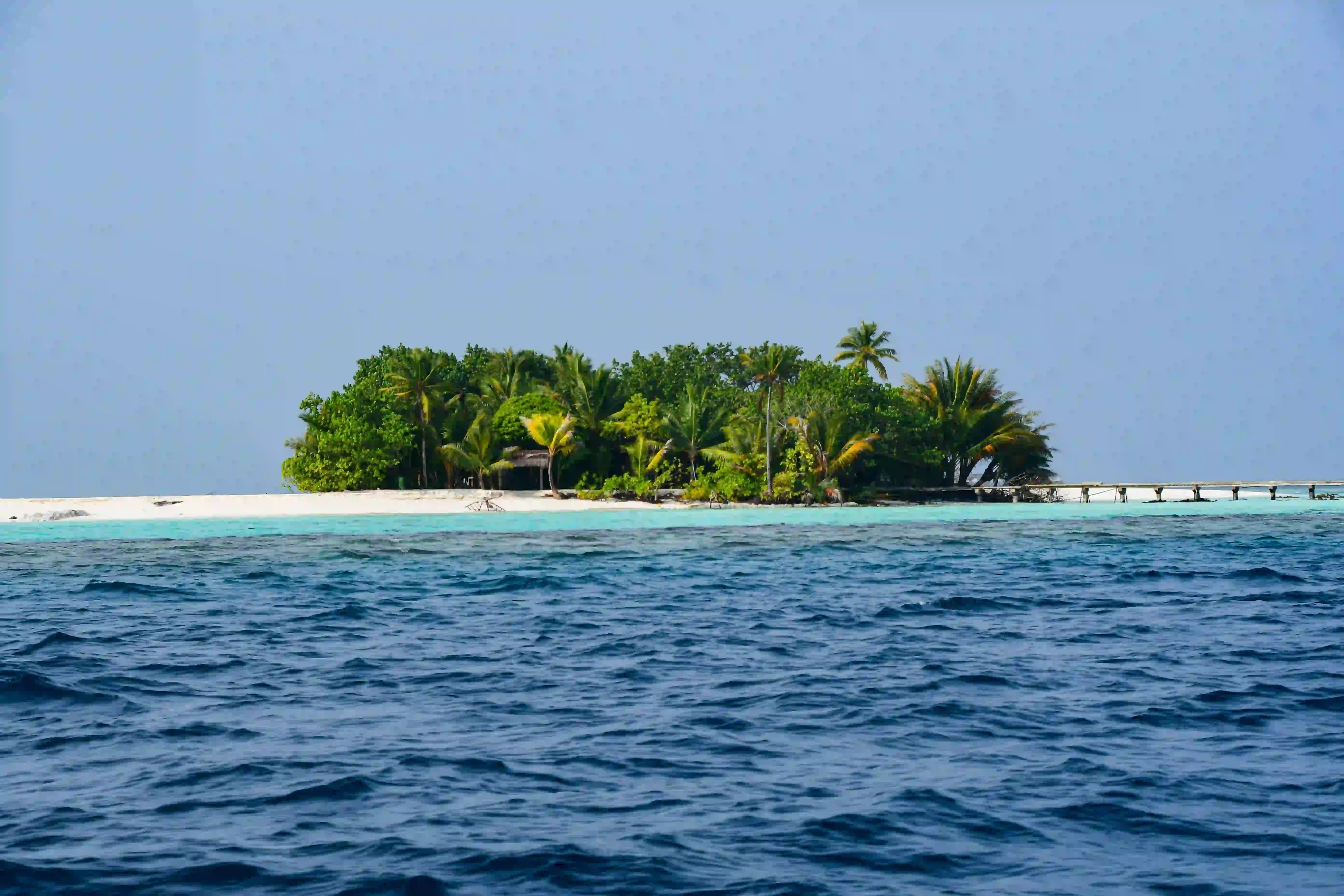 Sunny Beach with a lot of people and boats